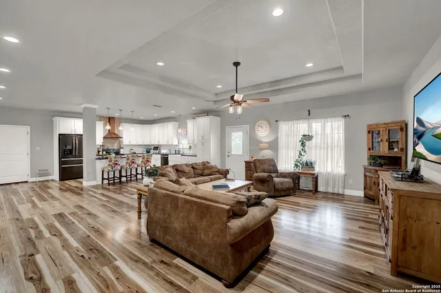 a living room with furniture and a chandelier