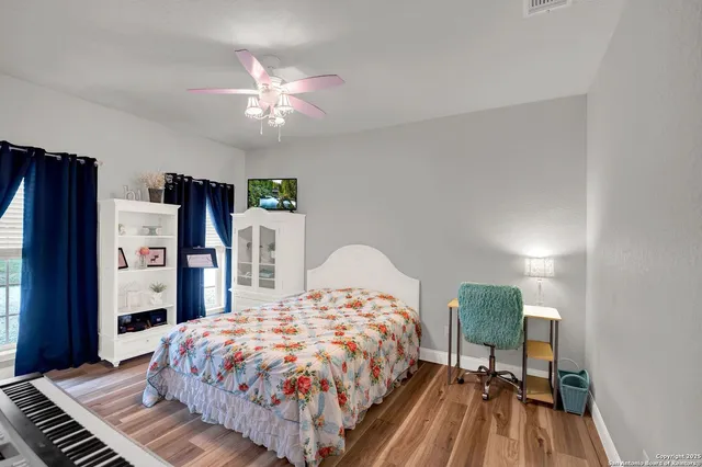 a bedroom with two beds and a window