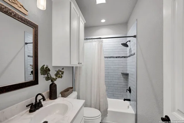 a bedroom with a bed chandelier and a couch