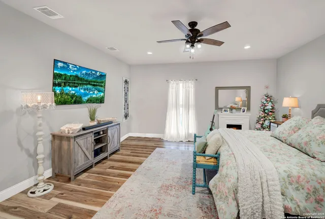 a spacious bathroom with double vanity a mirror and shower