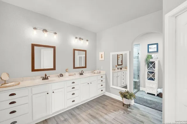 a bathroom with a shower and a sink