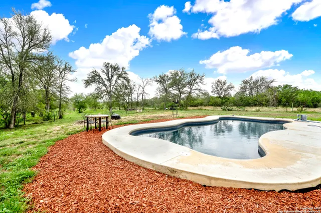 a view of a swimming pool with a yard