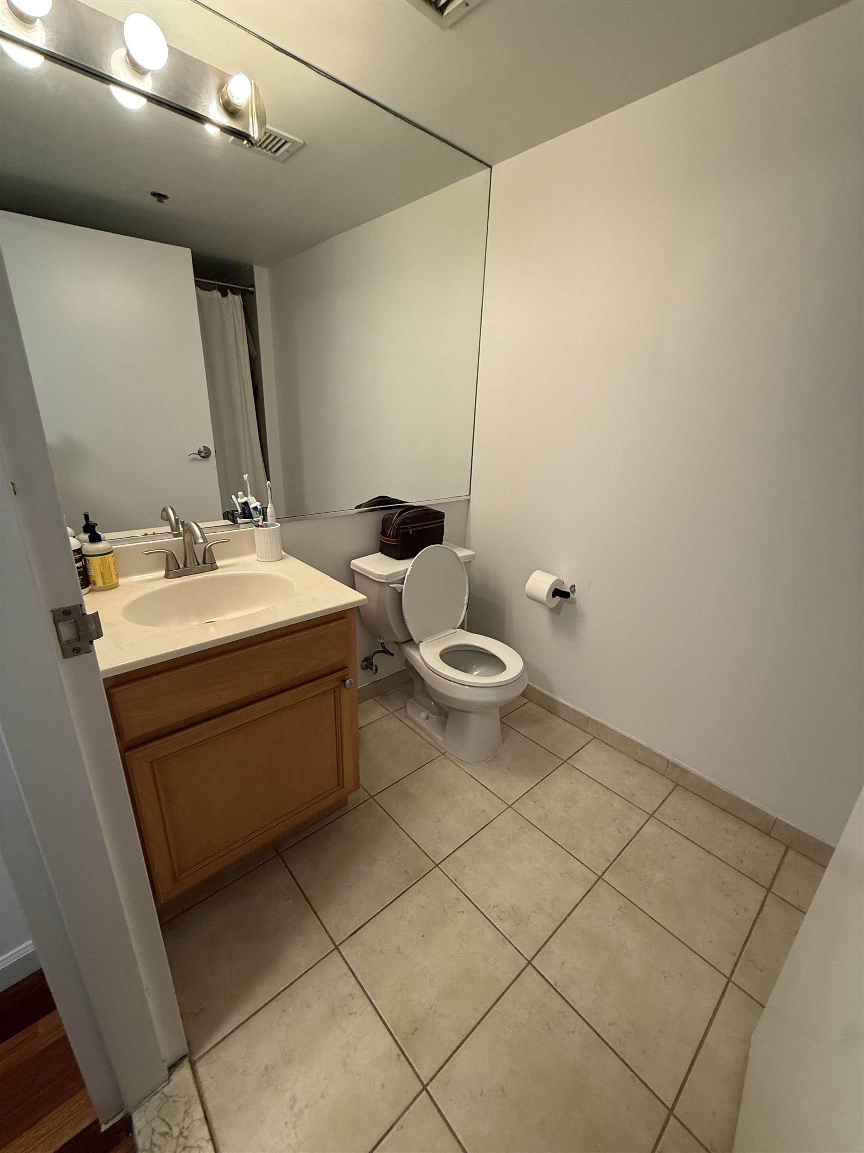 700 1st Street, Unit 2R Hoboken, NJ 07030 - Photo 6 of 13 a bathroom with a sink toilet and mirror