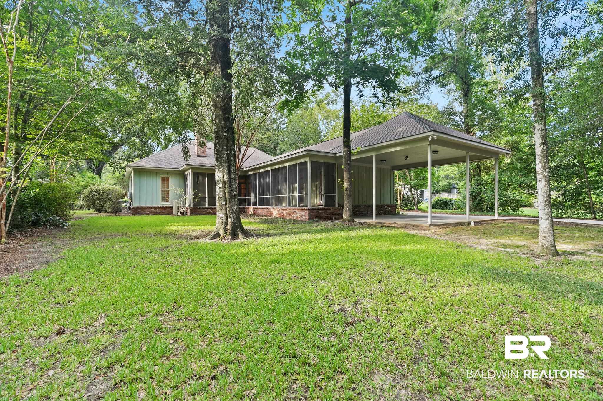 202 Beall Lane Daphne, AL 36526 - Photo 38 of 46 Rear view of house featuring a yard and a sunroom