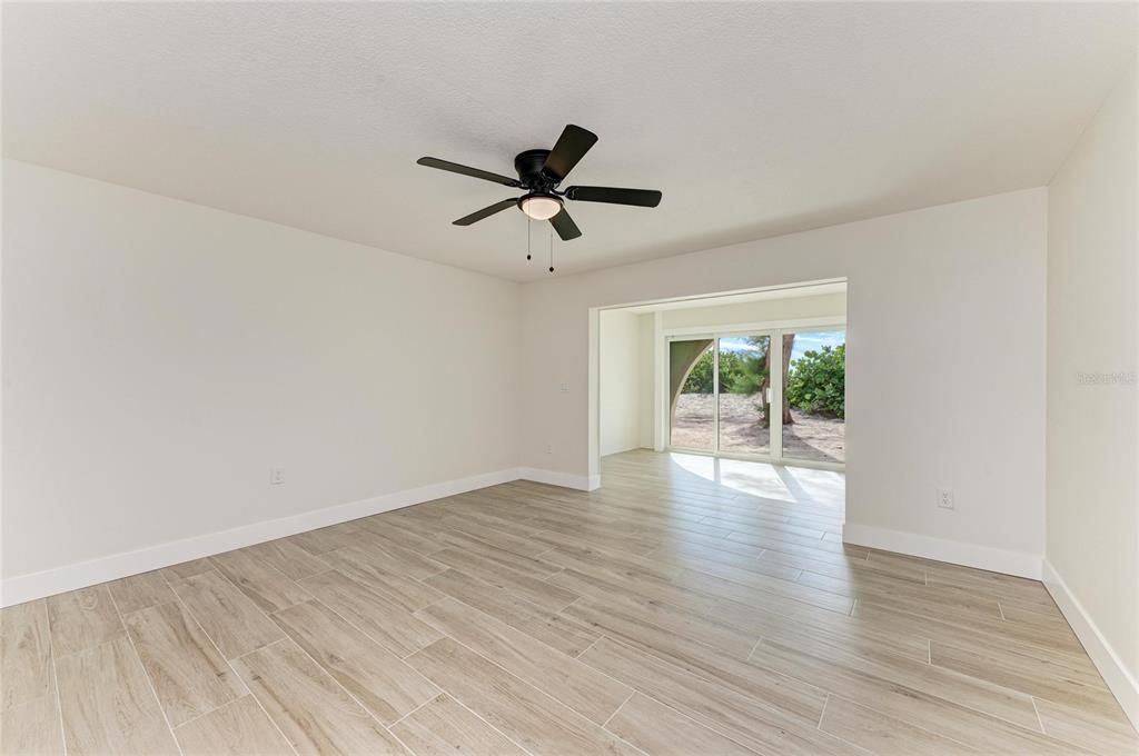 101 73rd Street, Unit 3 Holmes Beach, FL 34217 - Photo 15 of 53 a view of empty room with wooden floor and fan