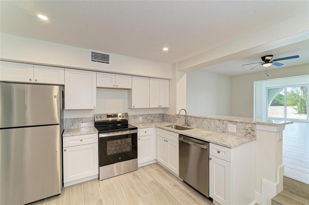 101 73rd Street, Unit 3 Holmes Beach, FL 34217 - Photo 16 of 53 a kitchen with a stove a refrigerator and a sink