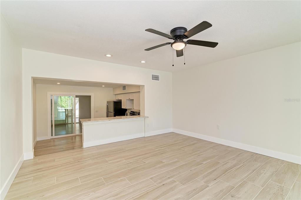101 73rd Street, Unit 3 Holmes Beach, FL 34217 - Photo 23 of 53 a view of empty room with wooden floor and ceiling fan
