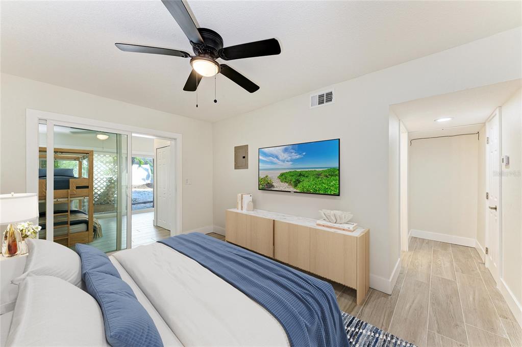 101 73rd Street, Unit 3 Holmes Beach, FL 34217 - Photo 24 of 53 a bedroom with a bed and a flat screen tv
