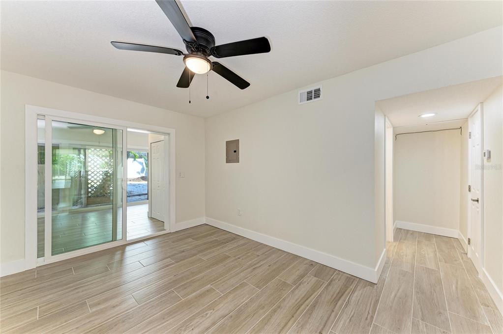 101 73rd Street, Unit 3 Holmes Beach, FL 34217 - Photo 25 of 53 a view of empty room with wooden floor and fan