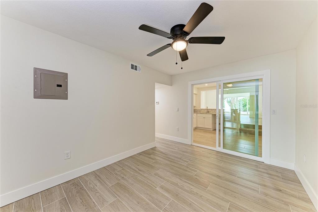 101 73rd Street, Unit 3 Holmes Beach, FL 34217 - Photo 27 of 53 an empty room with wooden floor and windows