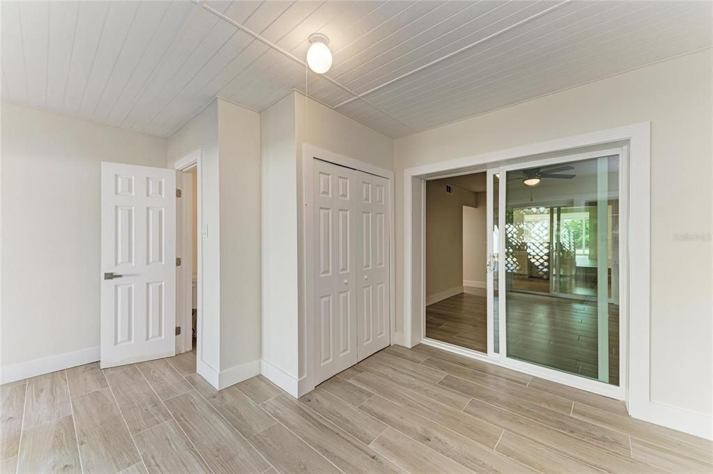 101 73rd Street, Unit 3 Holmes Beach, FL 34217 - Photo 31 of 53 a view of an empty room with wooden floor and a window