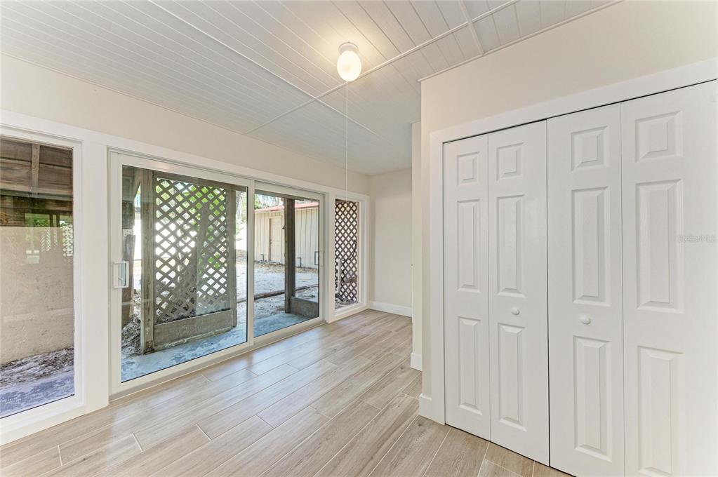 101 73rd Street, Unit 3 Holmes Beach, FL 34217 - Photo 33 of 53 an empty room with wooden floor and windows