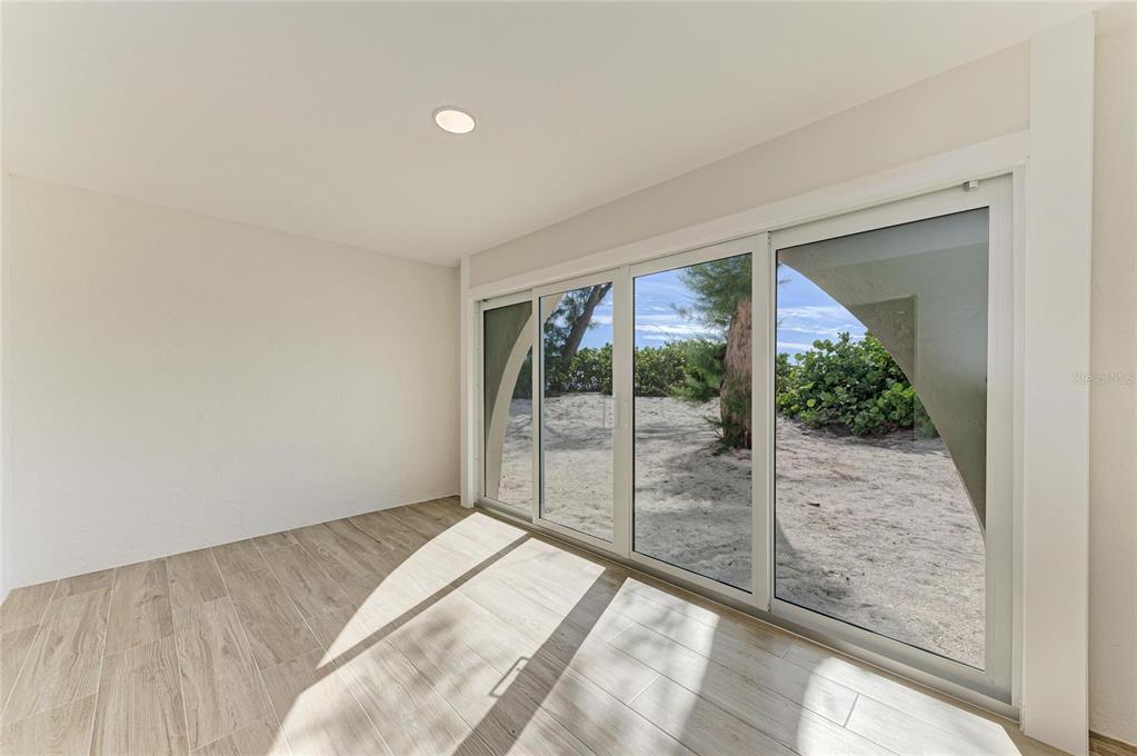 101 73rd Street, Unit 3 Holmes Beach, FL 34217 - Photo 34 of 53 a bedroom with a bed and a large window