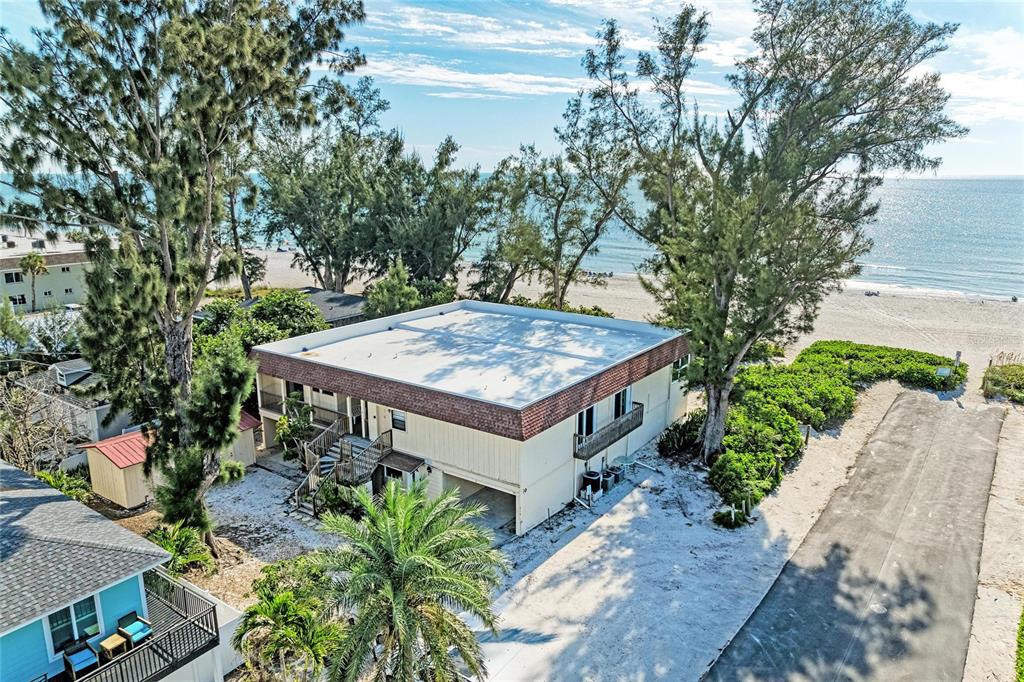101 73rd Street, Unit 3 Holmes Beach, FL 34217 - Photo 8 of 53 a view of a house with a yard and large trees