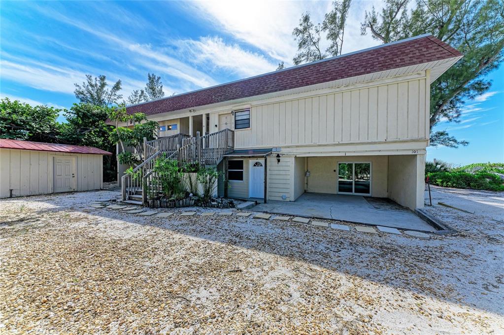 101 73rd Street, Unit 3 Holmes Beach, FL 34217 - Photo 9 of 53 a view of a house with a yard and garage