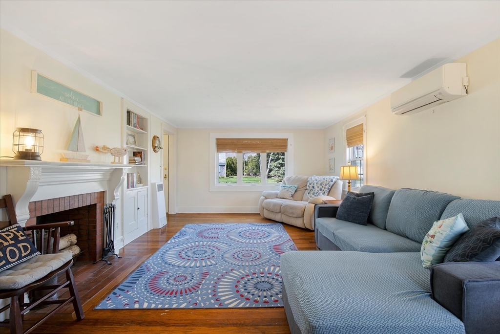 69 Jericho Path Falmouth, MA 02540 - Photo 15 of 42 a living room with furniture and a fireplace