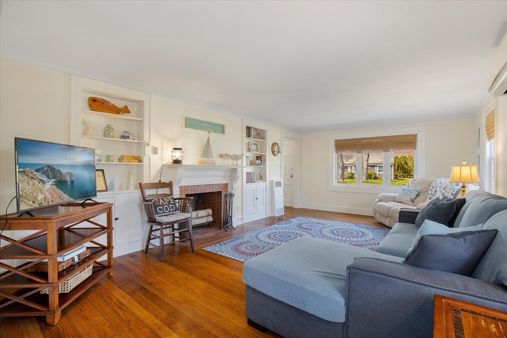 69 Jericho Path Falmouth, MA 02540 - Photo 16 of 42 a living room with furniture and a fireplace