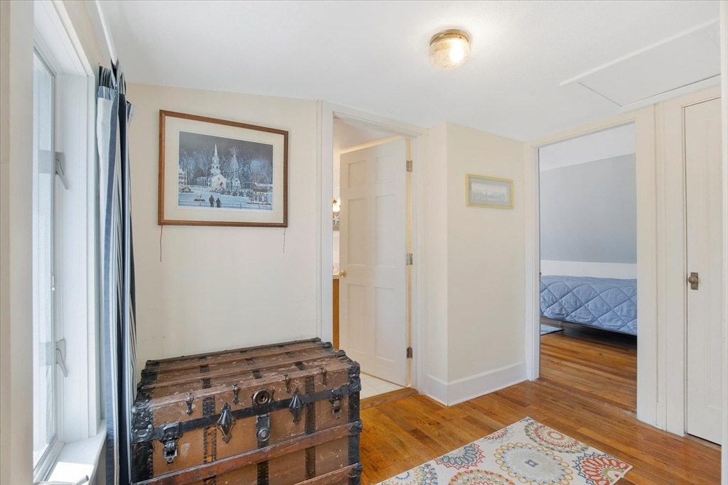 69 Jericho Path Falmouth, MA 02540 - Photo 25 of 42 a bedroom with a bed and wooden floor