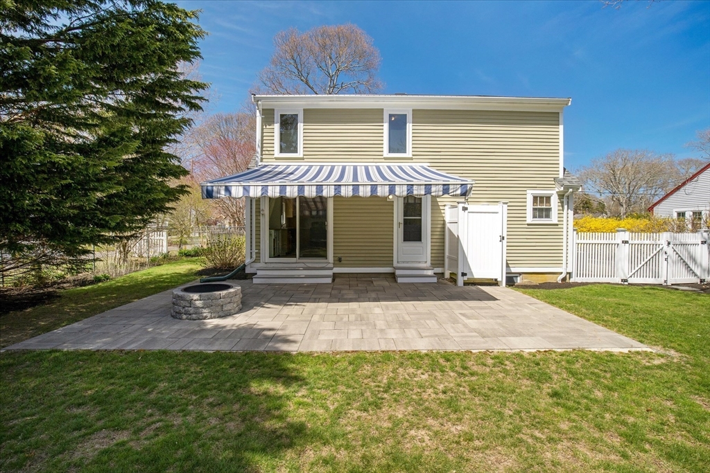 69 Jericho Path Falmouth, MA 02540 - Photo 32 of 42 a front view of a house with a yard and garage