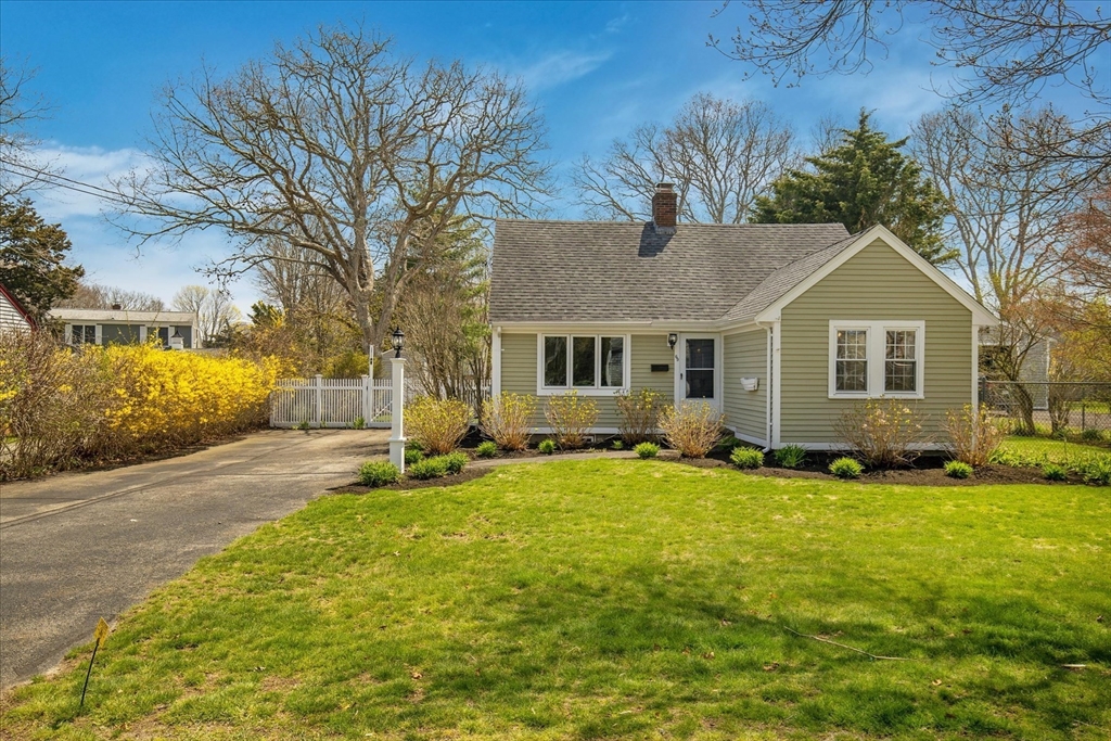 69 Jericho Path Falmouth, MA 02540 - Photo 4 of 42 a front view of a house with a yard