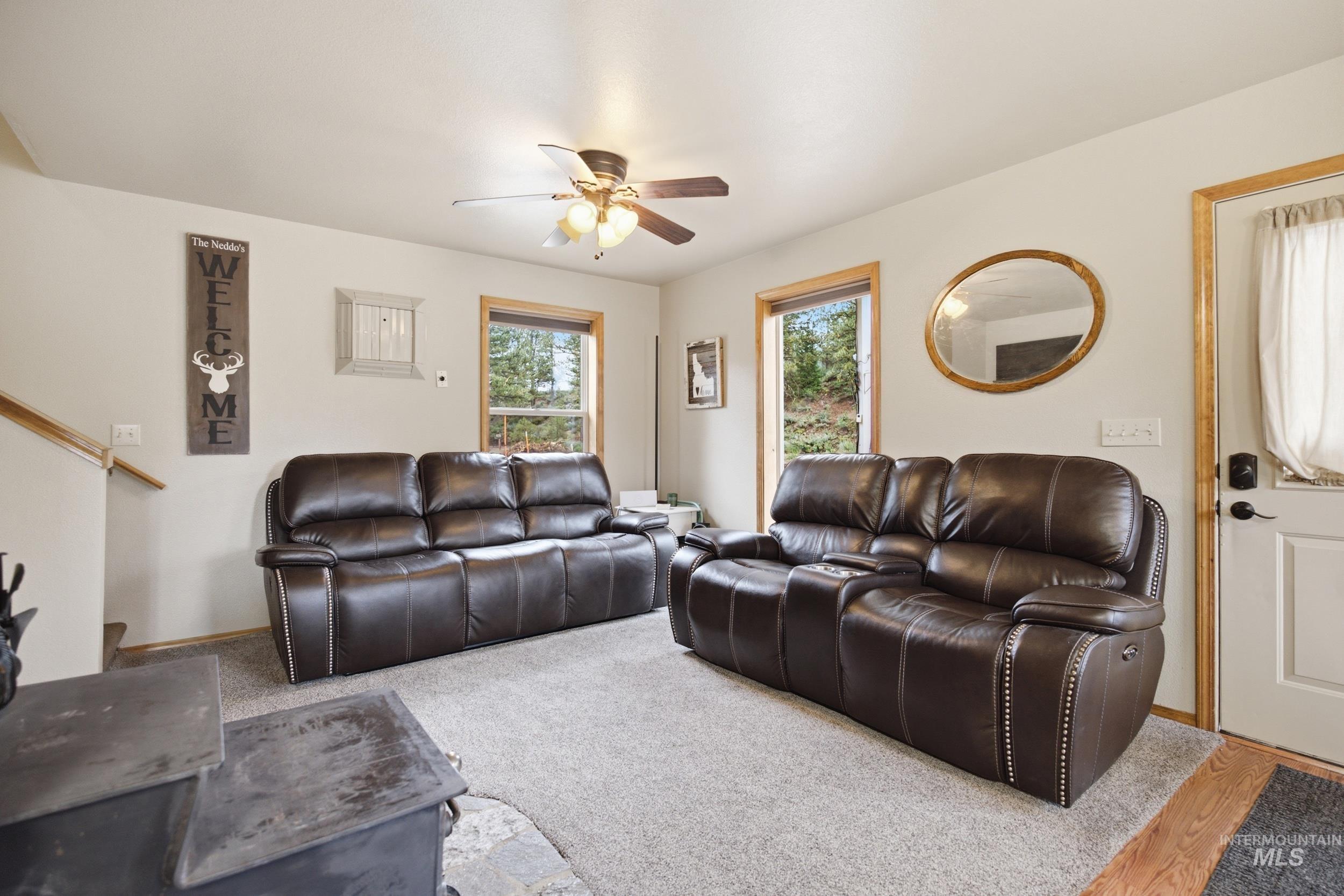 3980 North Pine-Featherville Road Mountain Home, ID 83647 - Photo 15 of 35 Inviting living area featuring light neutral walls and gray carpeting