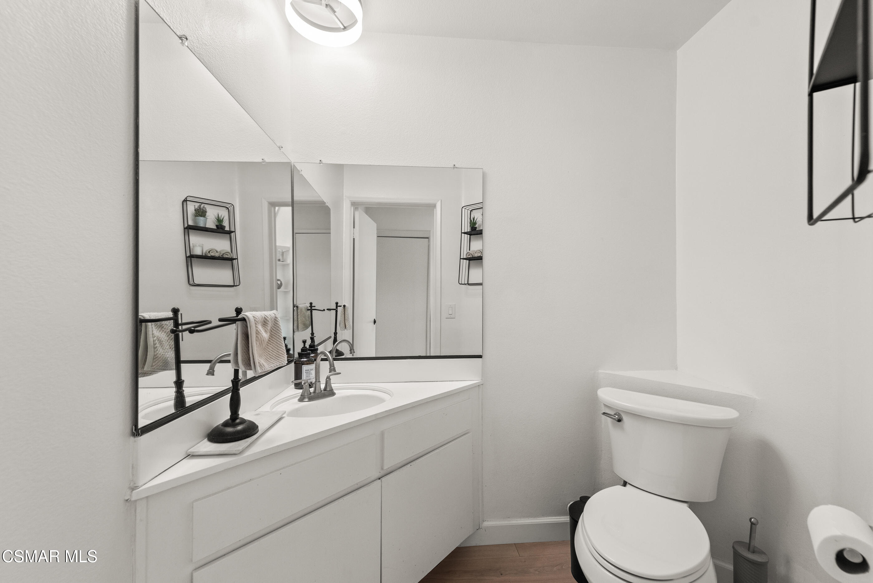 1730 Sinaloa Road, Unit 310 Simi Valley, CA 93065 - Photo 12 of 36 a bathroom with a toilet sink and mirror