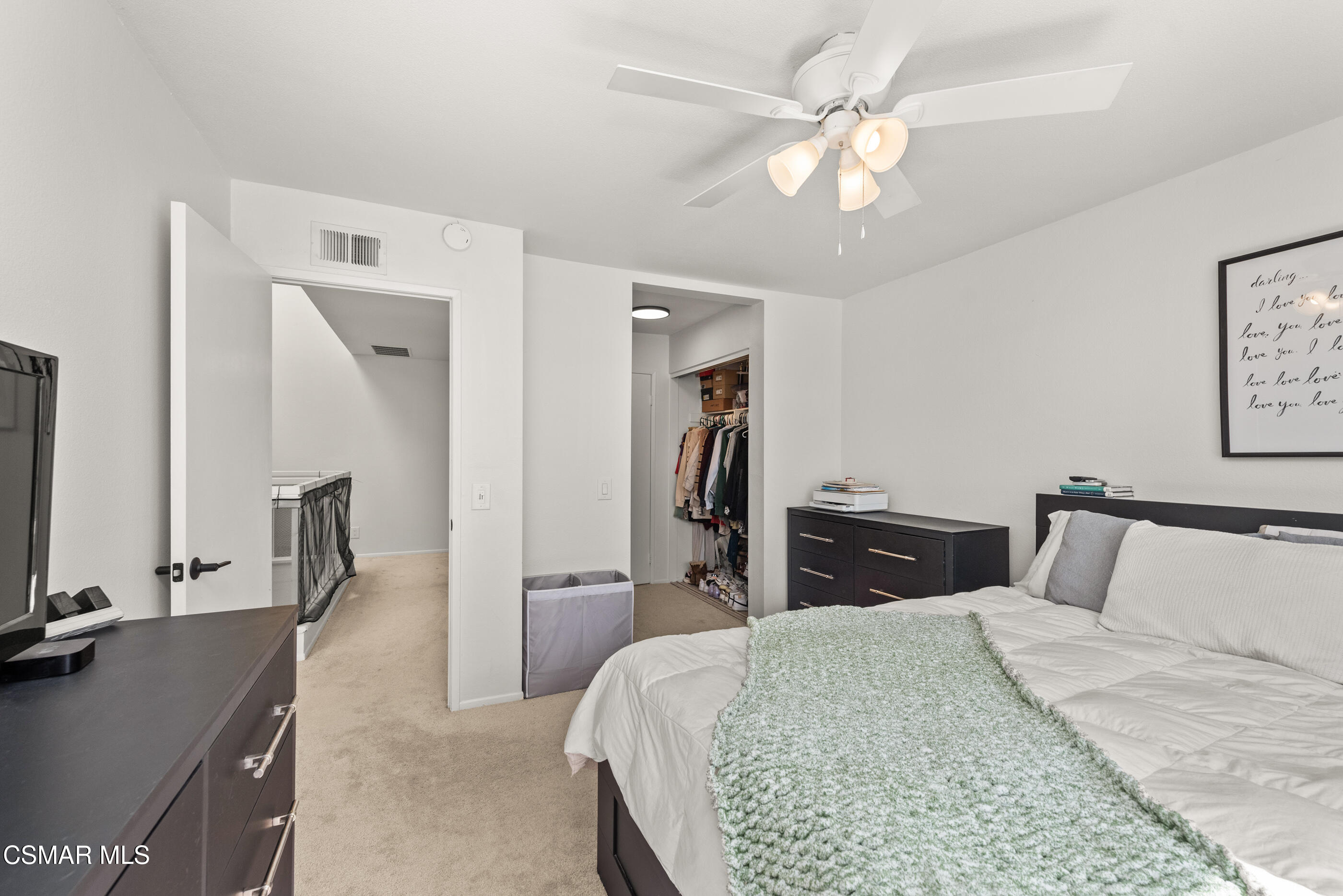 1730 Sinaloa Road, Unit 310 Simi Valley, CA 93065 - Photo 17 of 36 a bedroom with a bed and a chandelier