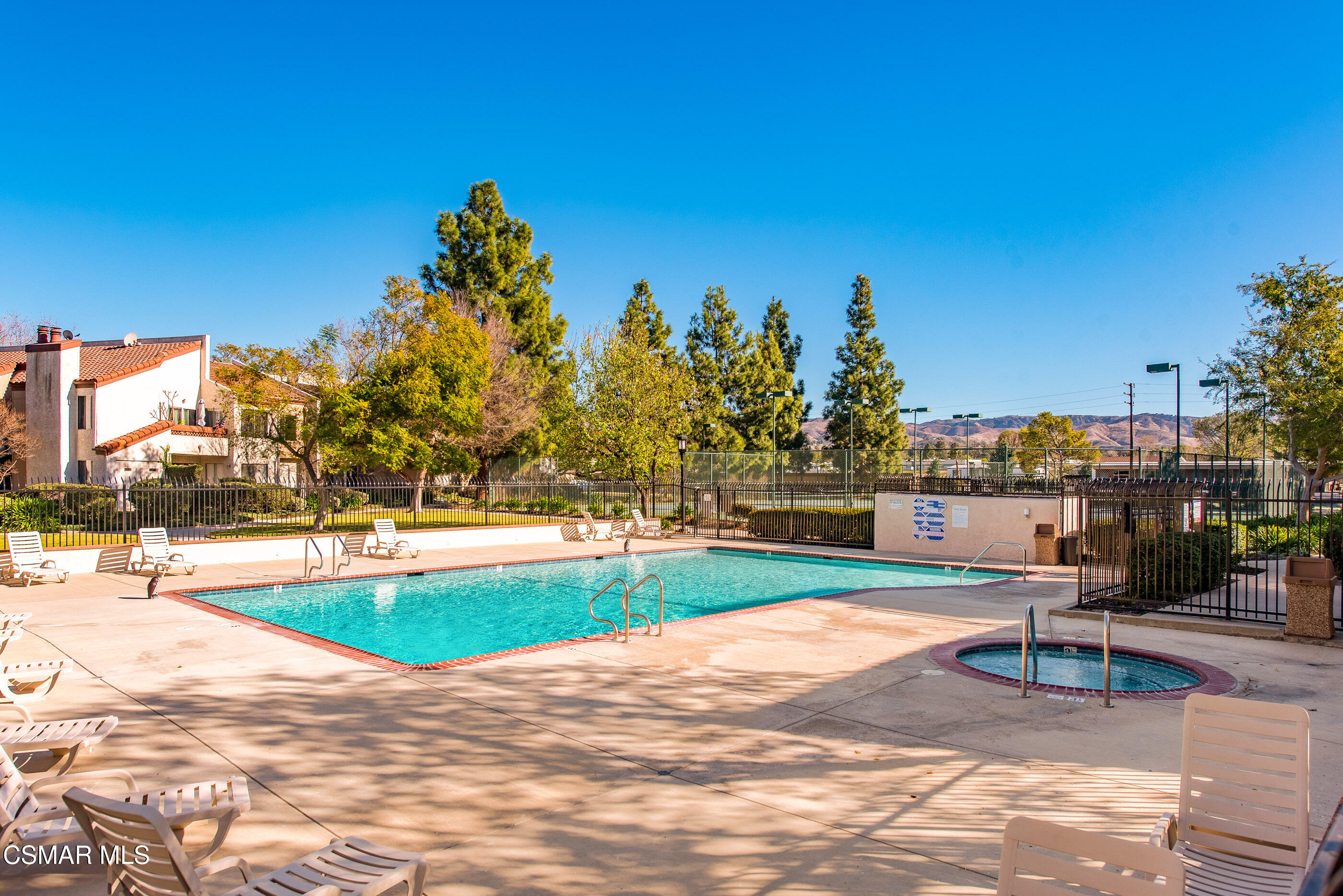 1730 Sinaloa Road, Unit 310 Simi Valley, CA 93065 - Photo 30 of 36 a view of a swimming pool with an outdoor space and seating area