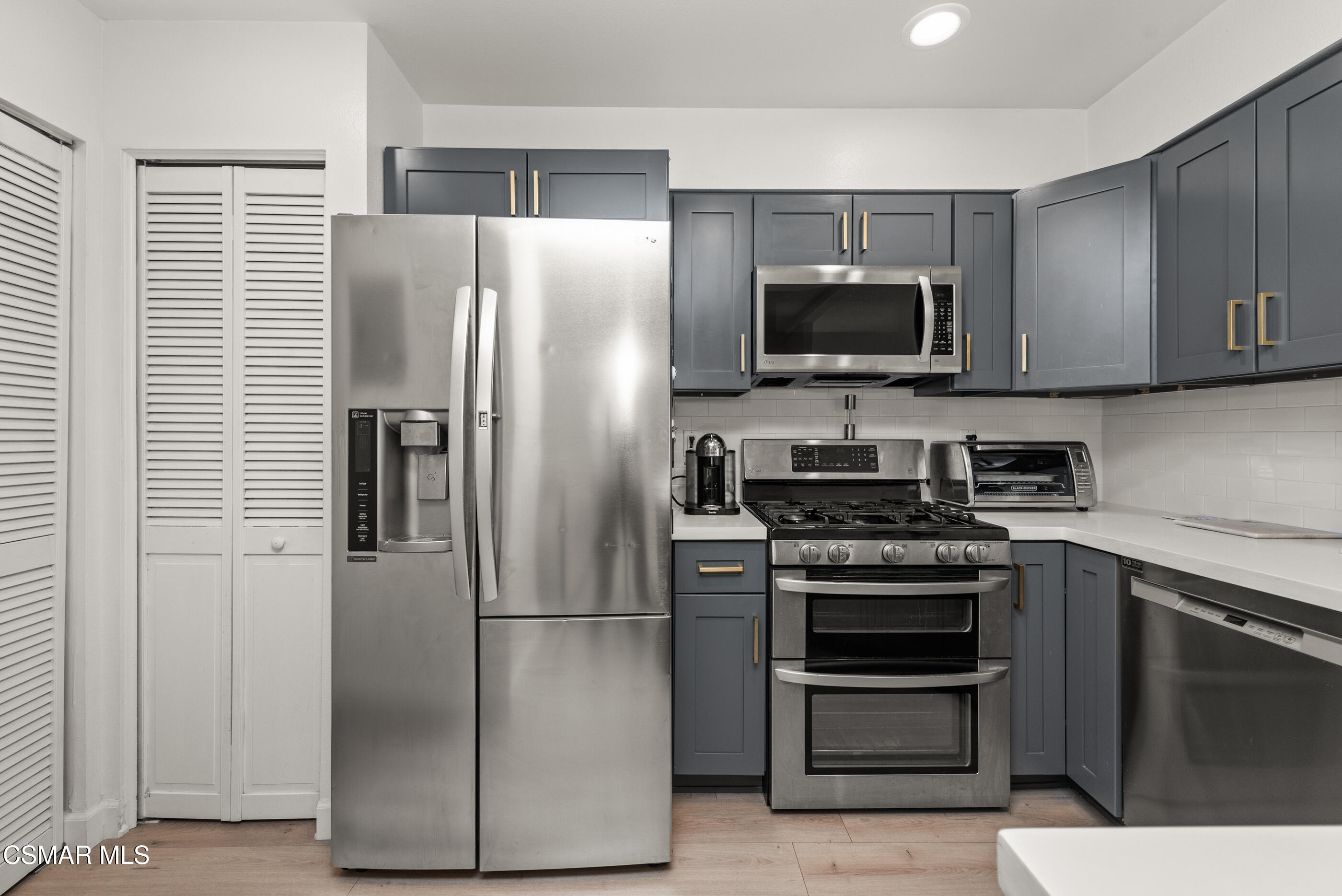 1730 Sinaloa Road, Unit 310 Simi Valley, CA 93065 - Photo 8 of 36 a kitchen with stainless steel appliances and refrigerator