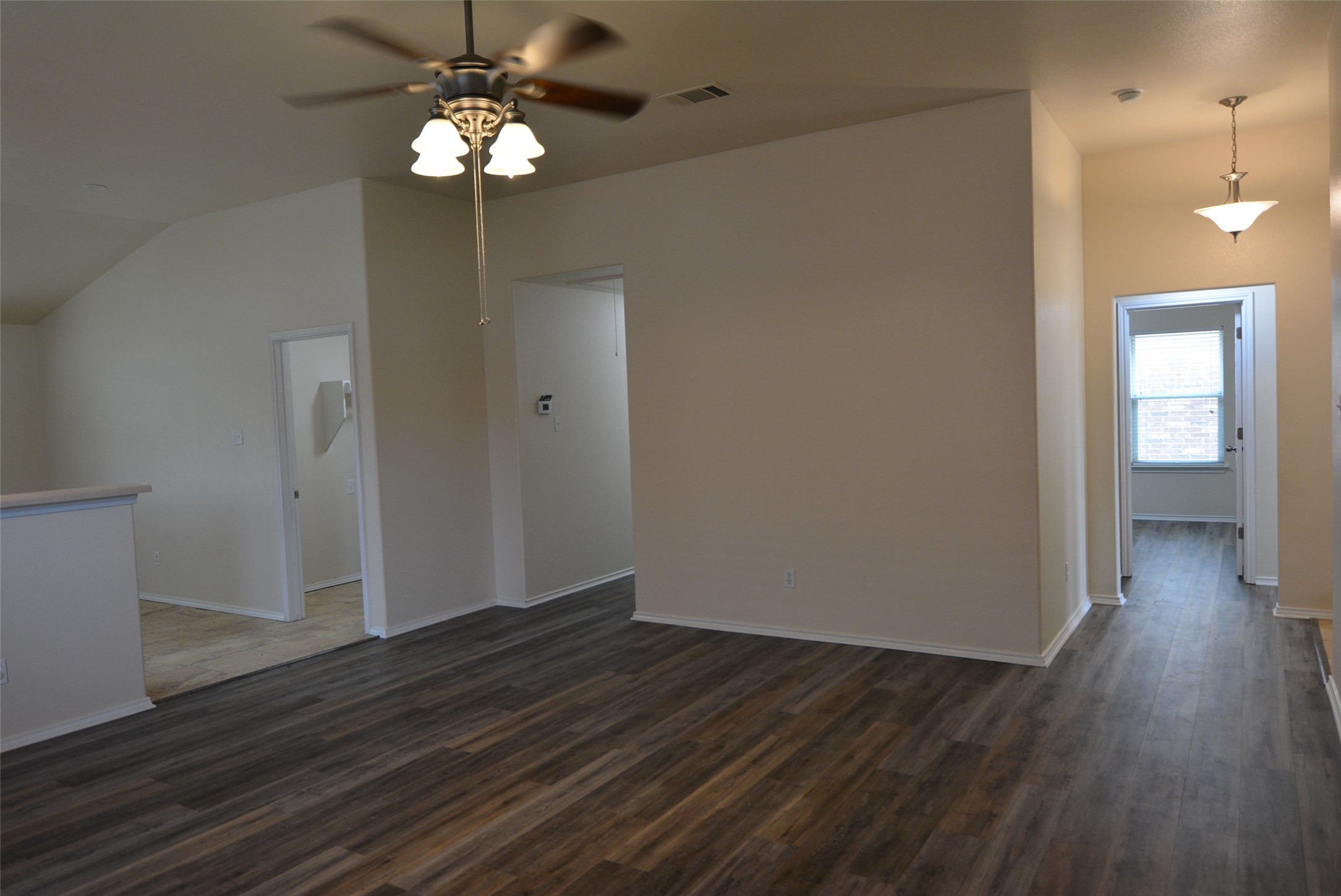 1303 Horseshoe Ranch Drive Leander, TX 78641 - Photo 11 of 26 A living space offers varied ceiling heights and durable plank flooring.