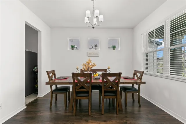 a view of a dining room with furniture and chandelier