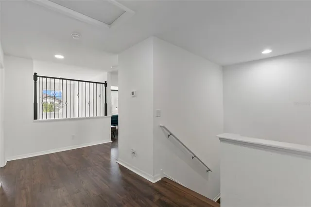 a view of a workspace with bookshelf and a workspace