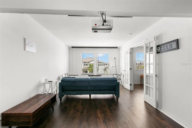 a bedroom with furniture and a wooden floor