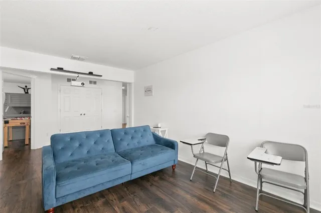 a bedroom with furniture and a wooden floor