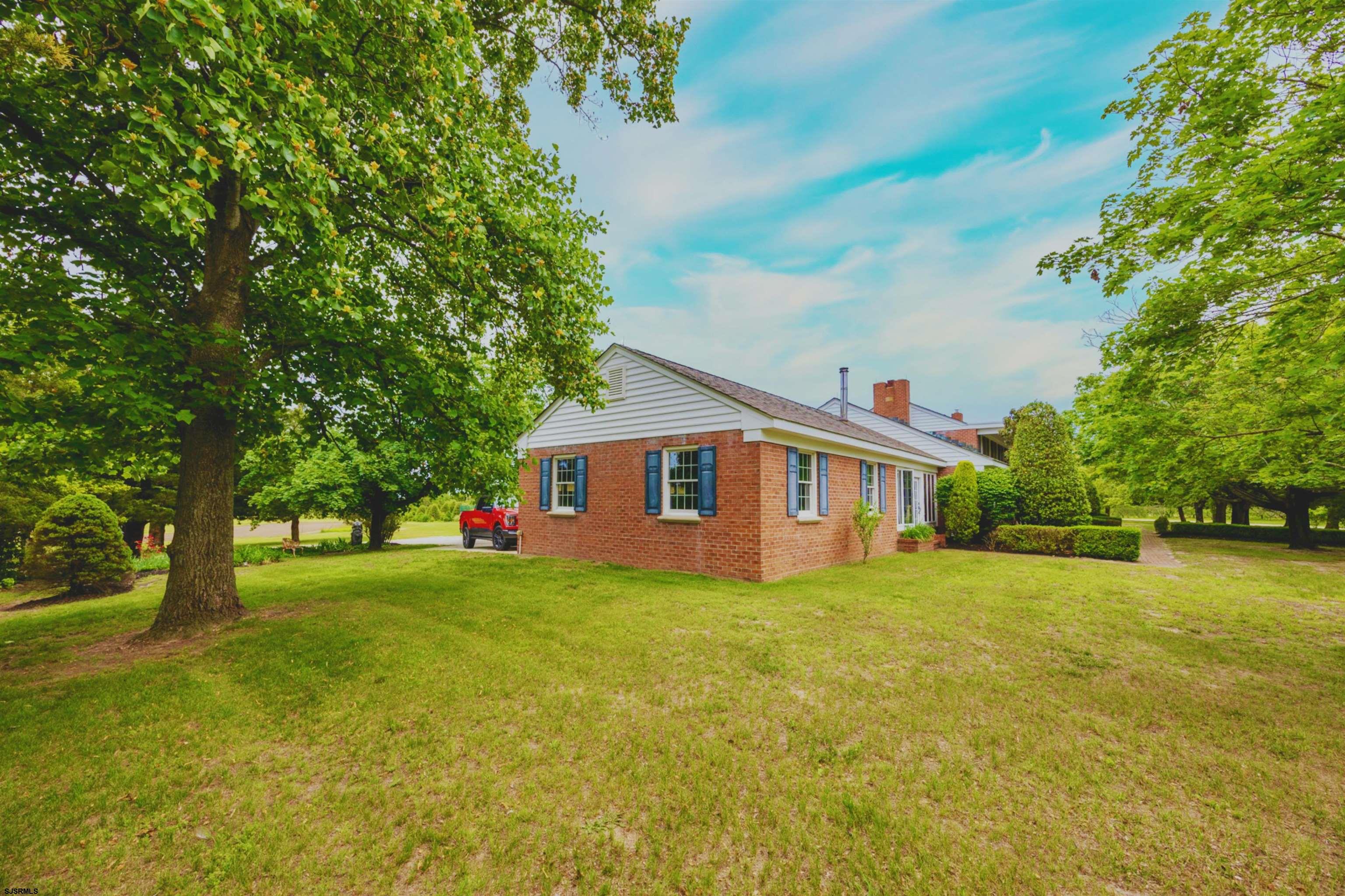 3065 North Route 9 Ocean View, NJ 08230 - Photo 11 of 99 a house that is sitting in the grass with tress in the background
