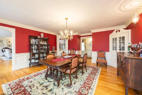 a living room with furniture a flat screen tv and floor to ceiling window