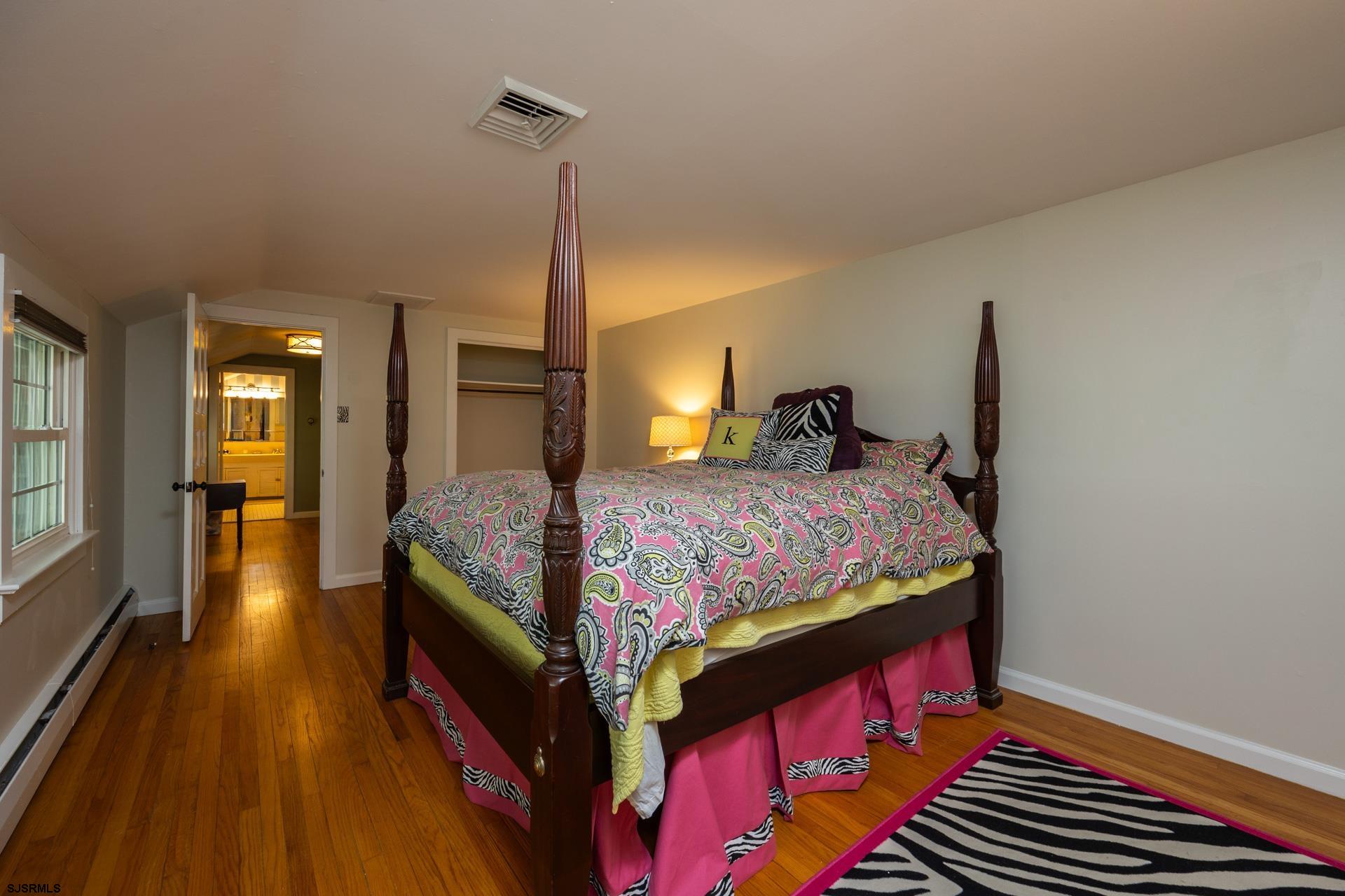 3065 North Route 9 Ocean View, NJ 08230 - Photo 54 of 99 a bedroom with a bed a dresser and wooden floor