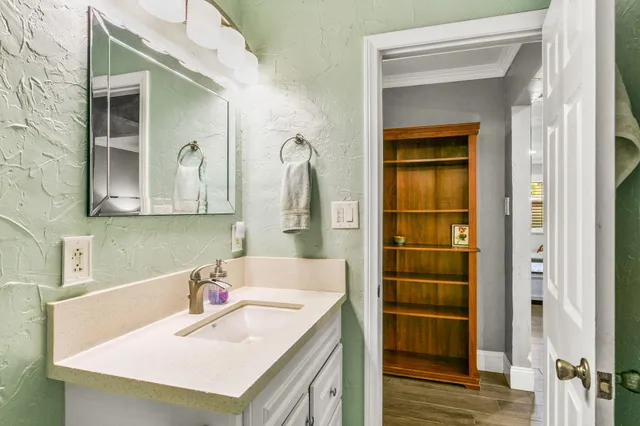 a bathroom with a sink vanity and a mirror