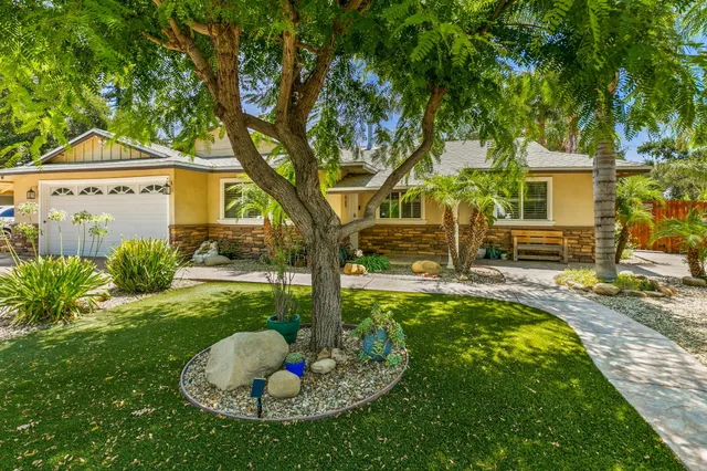 a view of a house with backyard and sitting area
