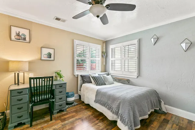 a bedroom with a bed and a chandelier