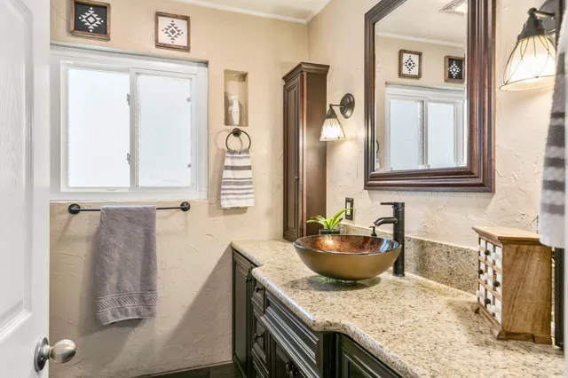 a kitchen with stainless steel appliances granite countertop a sink a stove and a refrigerator