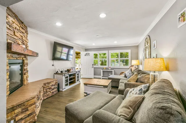 a living room with furniture flat screen tv and a fireplace