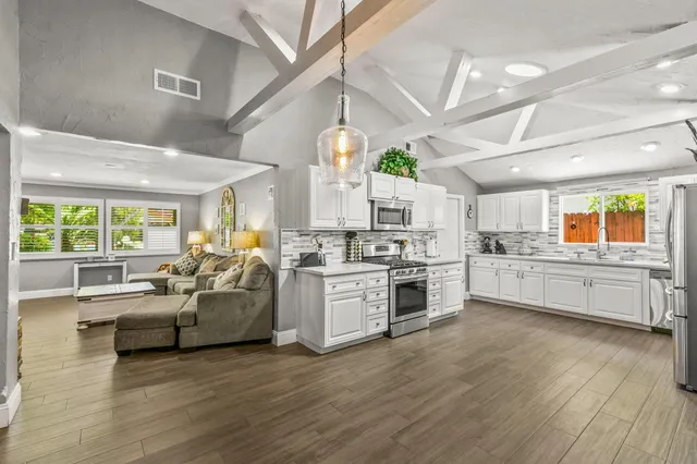 a kitchen with stove and cabinets