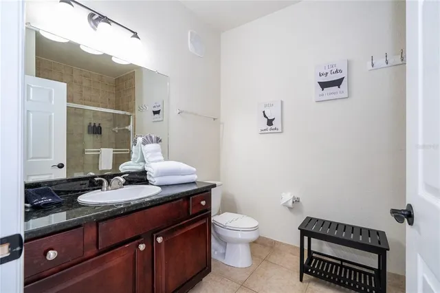 a bedroom with a bed and a lamp on table