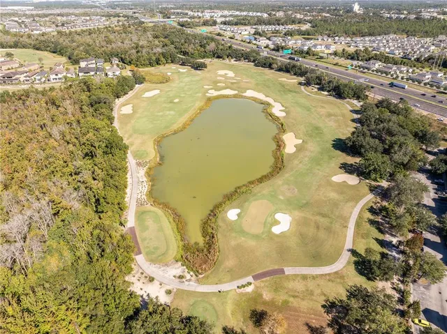a kitchen with kitchen island granite countertop wooden cabinets and white appliances
