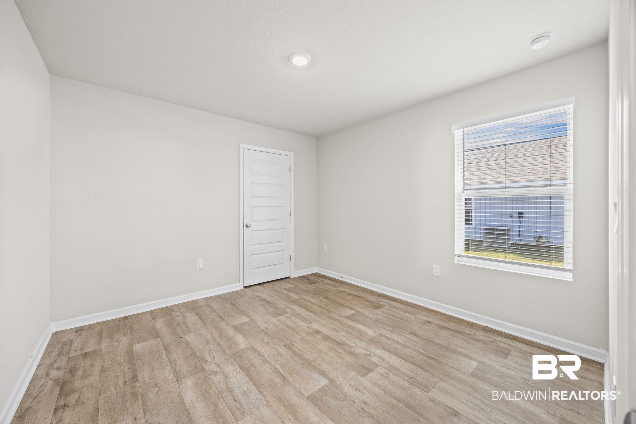 3090 Camino Real Loop Lillian, AL 36549 - Photo 21 of 29 Unfurnished room with light wood finished floors and baseboards