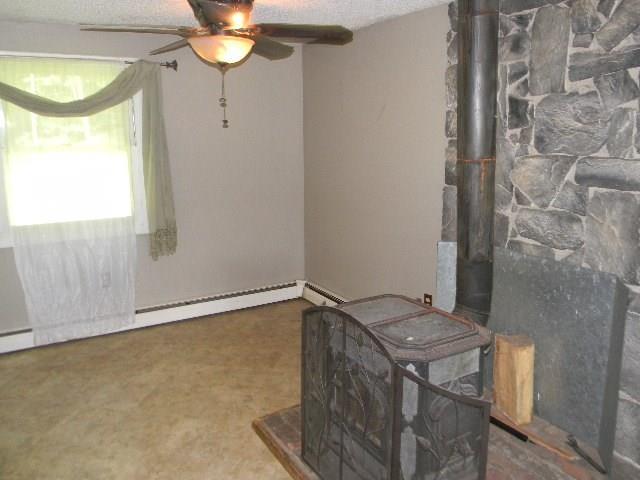 26 Keith Street Chelsea, ME 04330 - Photo 6 of 25 Wood stove off eat in kitchen area...
