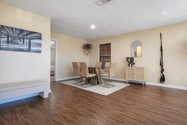 a view of a livingroom with furniture and wooden floor