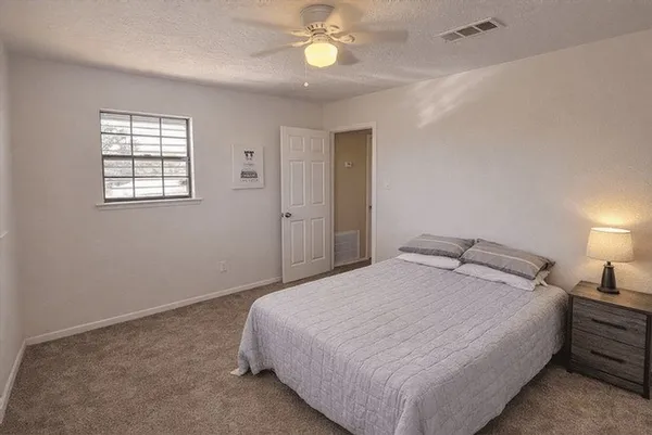 a bedroom with a bed and a lamp