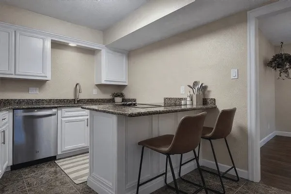 a kitchen with a sink cabinets and window